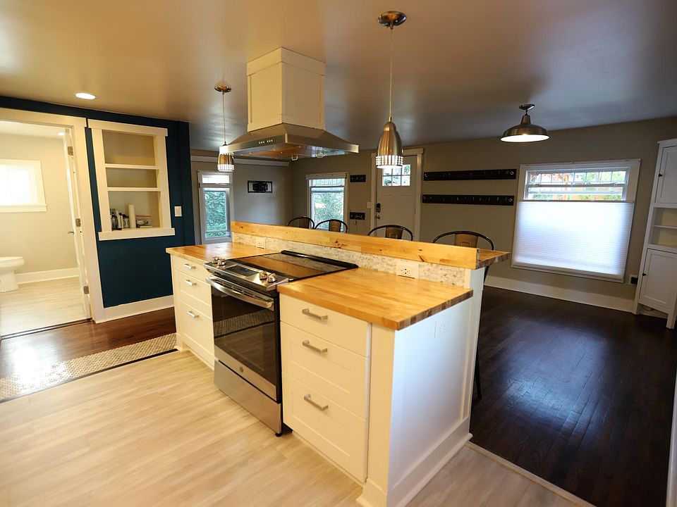 View from mud room into kitchen, with bath/living/dining in the background.