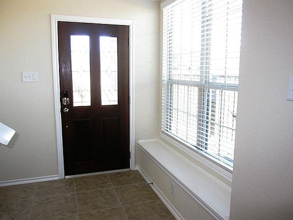 Raised panel mahogany door with beveled glass, Keyless entry lock. Window seat in entry