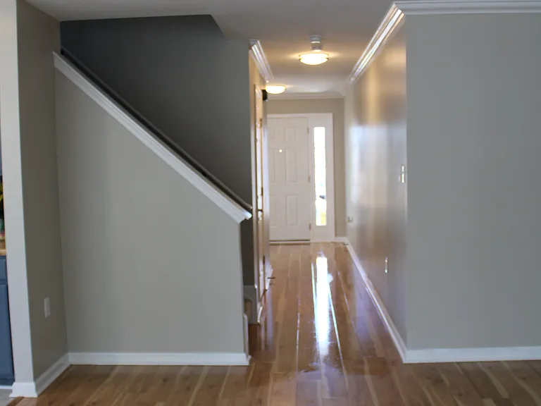 View from family room to Foyer entrance and stairs to upper level