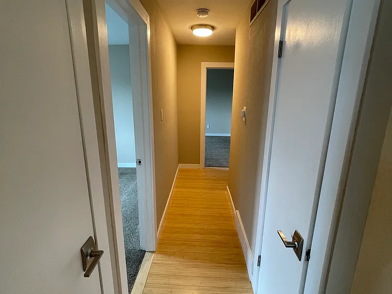 hallway leads to both bedrooms, two storage closets, updated bathroom