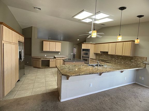 giant size kitchen with loads of storage, double oven, a large island, and dual kitchen sinks