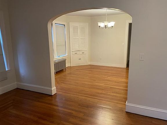 Large open dining room with two built in cabinets. Nice authentic arch way opening into the living room and large entrance way into the kitchen.