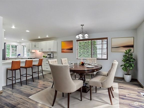 View from living room to dining and kitchen, virtually staged.>