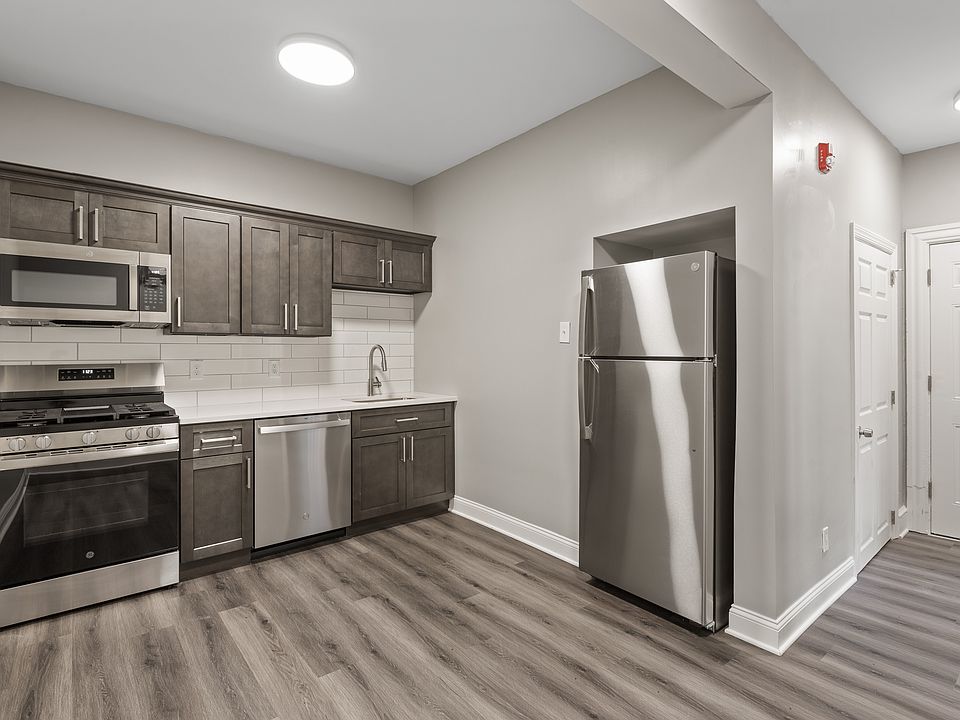 Kitchen with dishwasher, new cabinets, new appliances and quartz countertops.