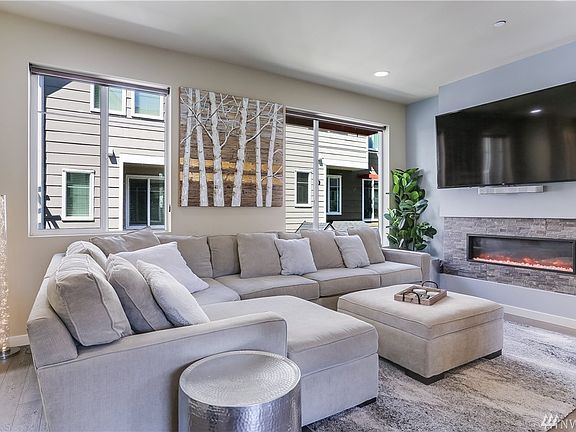 The living room is simply posh!  Two large windows look over the pathway that meanders through the complex.  Tall, 9-foot ceilings, white vinyl windows and AWESOME multicolor flame insert fireplace await you here!