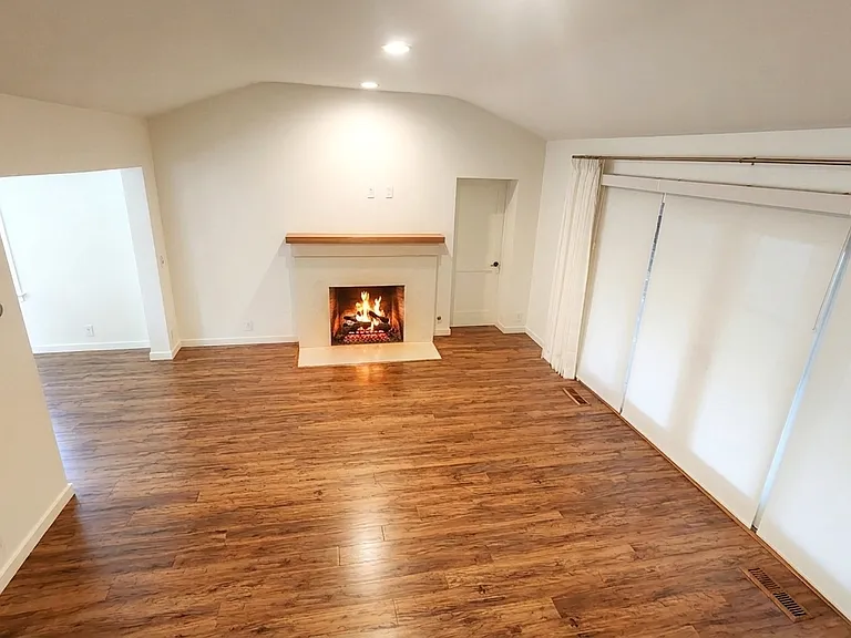 Living room, east-facing view. Gas fireplace, custom, motorized, light filtering privacy blinds shut.