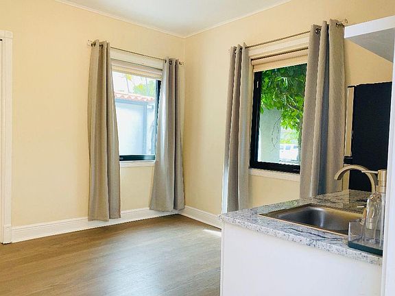 Front room. Kitchenette to the right. 2 windows with patio view and 1 closet.