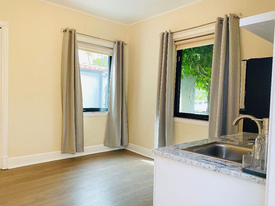 Front room. Kitchenette to the right. 2 windows with patio view and 1 closet.