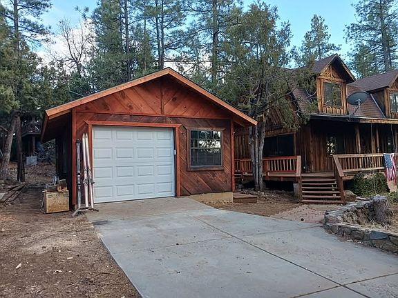10"x30' concrete driveway leading to a 16'x24' Single Car Garage / Workshop with lots of workspace and storage. Automatic garage door with remote opener.