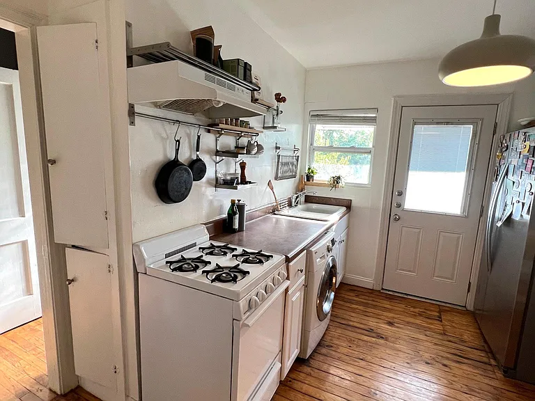 The happy kitchen with pine flooring.