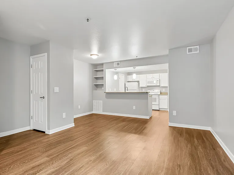 A Living Room with a view of the Kitchen at The Buttes Apartment Homes in Loveland, CO