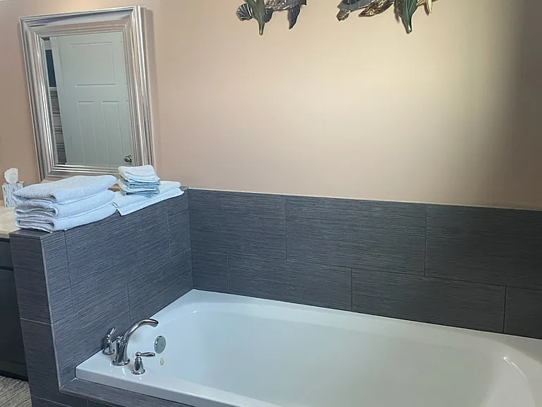Deep soaking tub in Upstairs Master Bathroom