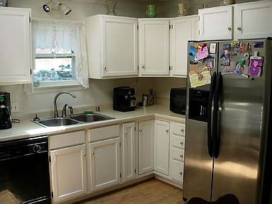 Country style kitchen with new stainless steel appliances.