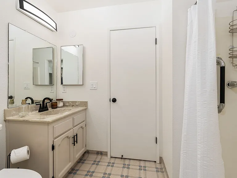 Master walk-through bathroom with shower stall.