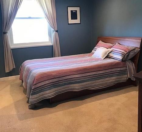 Serene bedroom with lots of light adjacent to the private bath