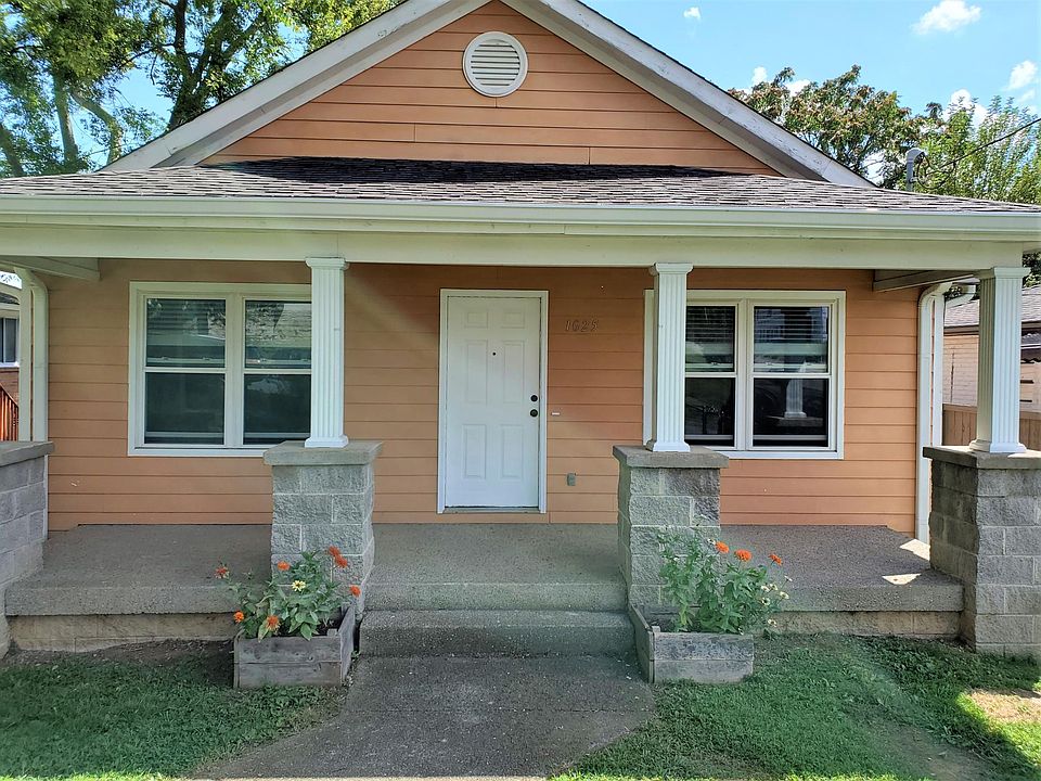 Covered front porch with garden beds for a small flower or herb garden.