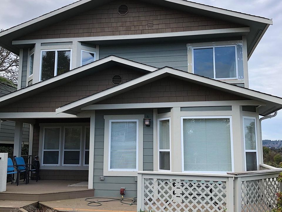 Front of house with porch, deck and covered entry.