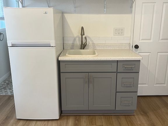 Kitchenette: refrigerator, sink, garbage disposal, and cabinets. The walk-in closet is to the right of the kitchenette. Bathroom is to the left of the kitchenette