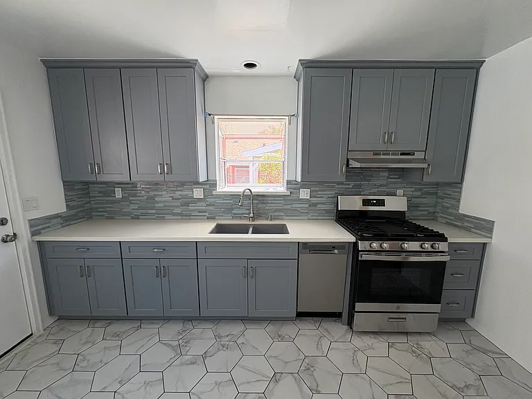 Recently remodeled kitchen with dishwasher and brand-new stove.