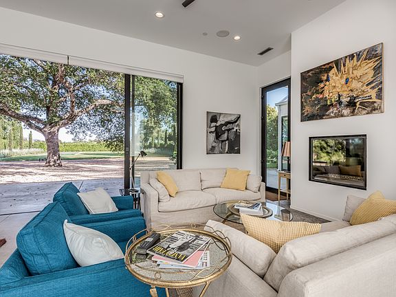 Living room looking to gas fireplace and garden beyond