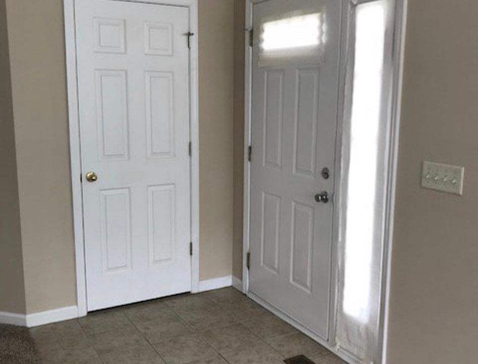 Tiled front entry with coat closet