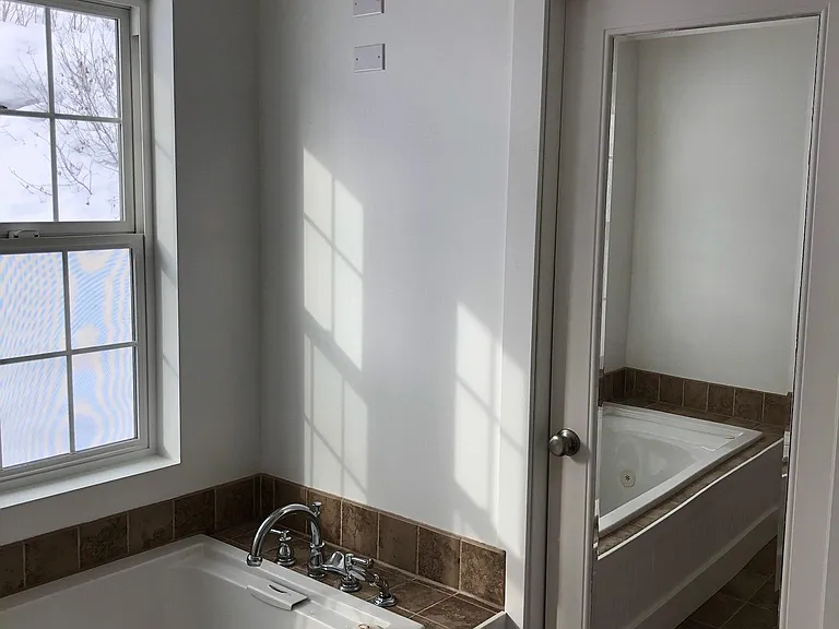 Master bath has pocket door separating sinks/tub from shower & toilet
