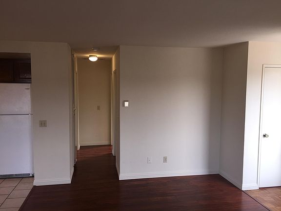 Hall Leading to Bedrooms from Living Room. Entry to West Bathroom to the Right, Linen Closet to Left.