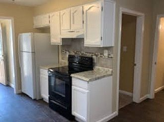Kitchen view towards bathroom and bedroom