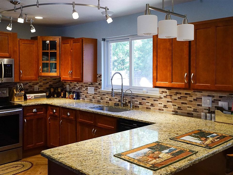 Gorgeous remodeled kitchen with granite counters, stainless appliances, and soft-close drawers.