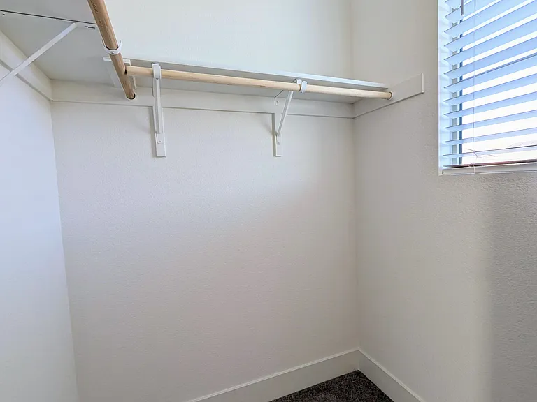 A standout feature is the walk-in closet, uniquely designed with a private window that fills the space with natural light, keeping your storage area fresh and bright.
