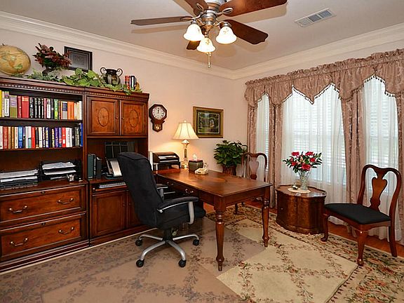 The study boasts double crown molding and is spacious enough for an executive desk!
