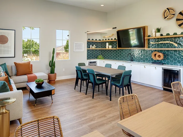 Resident lounge with entertaining kitchen, dining area, and lounge seating