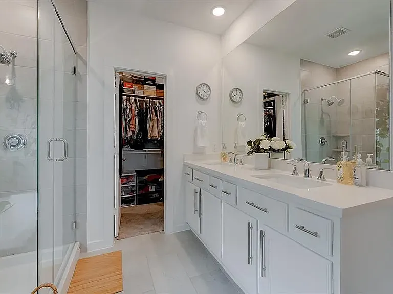 Shower and tub with a view of the master closet