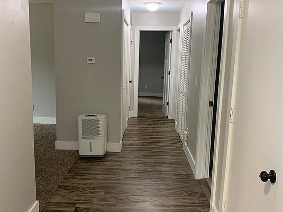 Looking from the entry door down hall to Laundry and Bedrooms on the right. Living room and Kitchen to the left