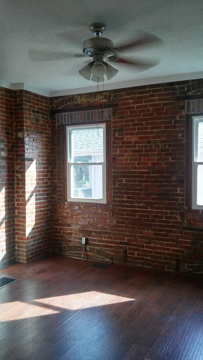 High ceilings with exposed brick. Ceiling fan, and hardwood - 2242 Grand Ave #B