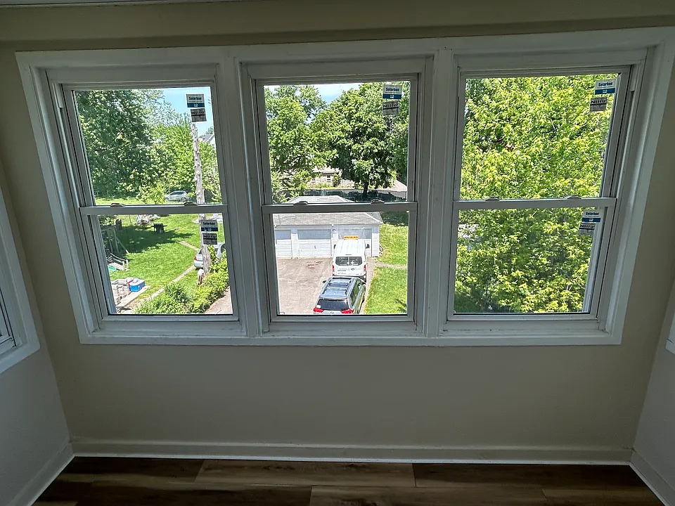 Back porch off kitchen. View of driveway and 3-car garage.