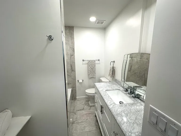 Guest full bathroom marble countertops and brand new vanity, tub and toilet
