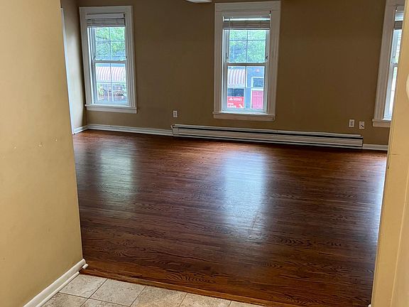 Large, open living space with hardwood floors. (tile floors in kitchen)