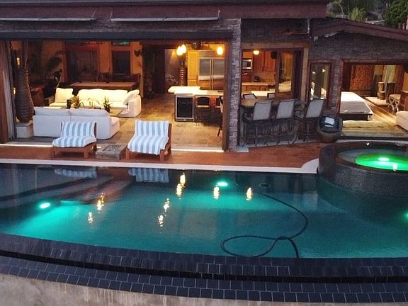 Dusk ariel shot of the pool deck. The great room is to the left and to the right is the master suite.