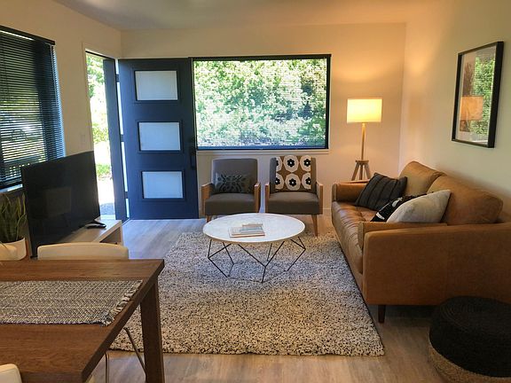 open concept living with large custom double pane windows, great light, nature and ocean views