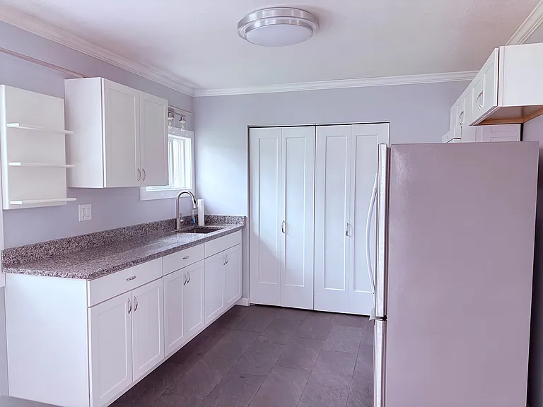 Kitchen View 1, New Windows, New Lighting, Washer/Dryer located behind bi-fold doors