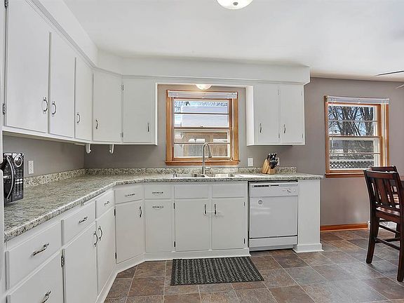 Sun drenched kitchen was remodeled in 2018 & features white cabinets and complete appliance package.