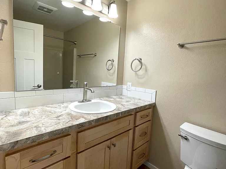 Hall bath for family and guests. It's got great storage!