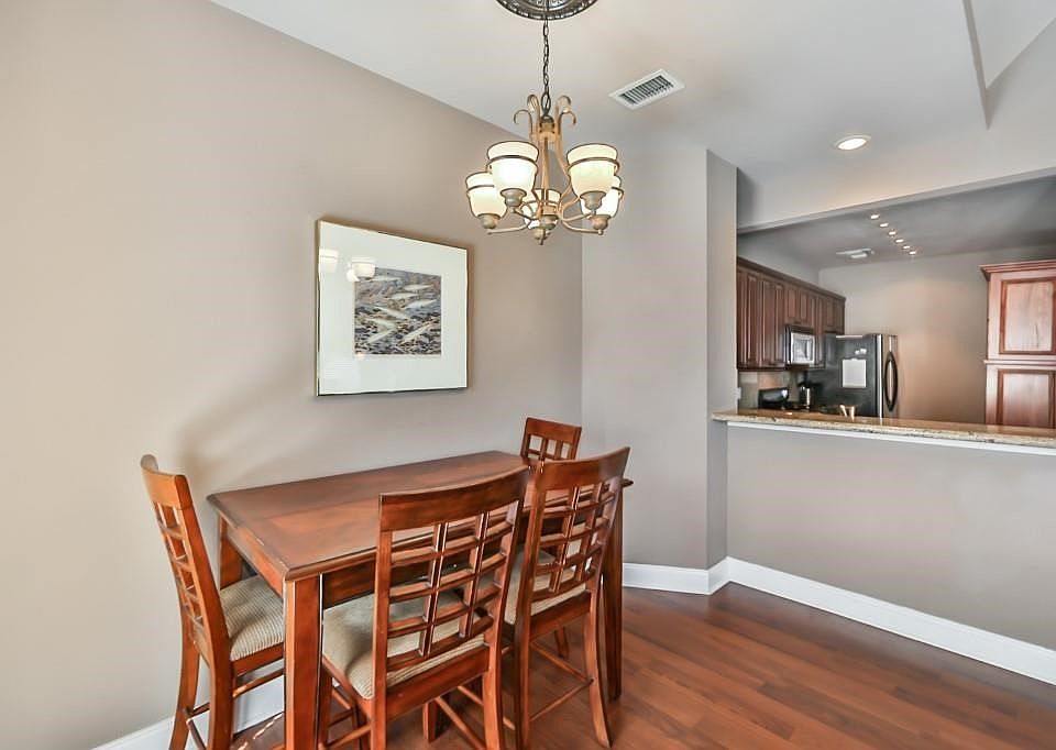 Dining are adjacent to the living with view of breakfast bar.