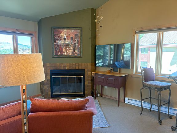 Upstairs living room with smart TV and wood fireplace