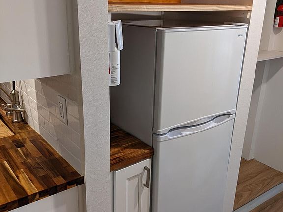 Fridge/freezer is 3/4 size. You could add a full-sized fridge in the garage.