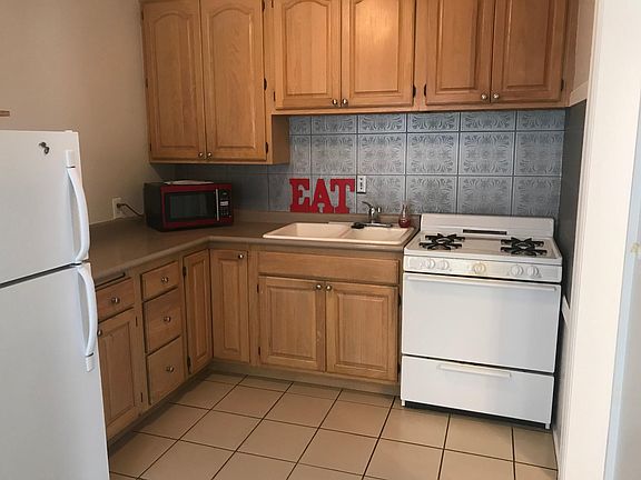functional kitchen, pantry closet in hall.