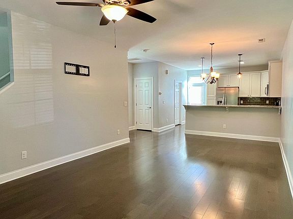 Main level living area with open floor plan, breakfast bar, and powder room.