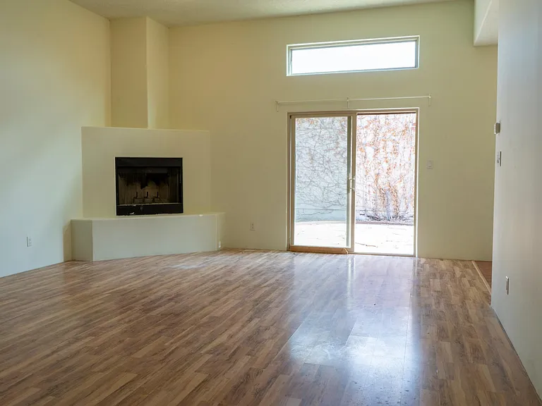 Living room with wood burning fireplace.Sliding door to yard and patio.