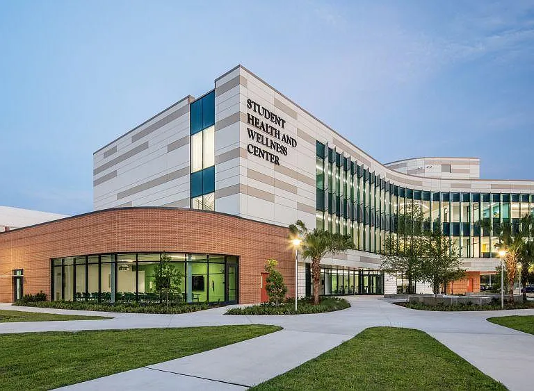 Well-maintained exterior with landscaped grounds, wide walkways, and a modern facade with ample windows.